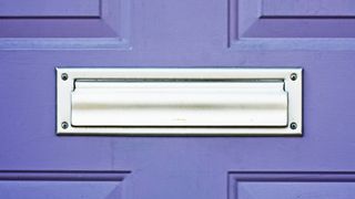 silver letterbox in purple door