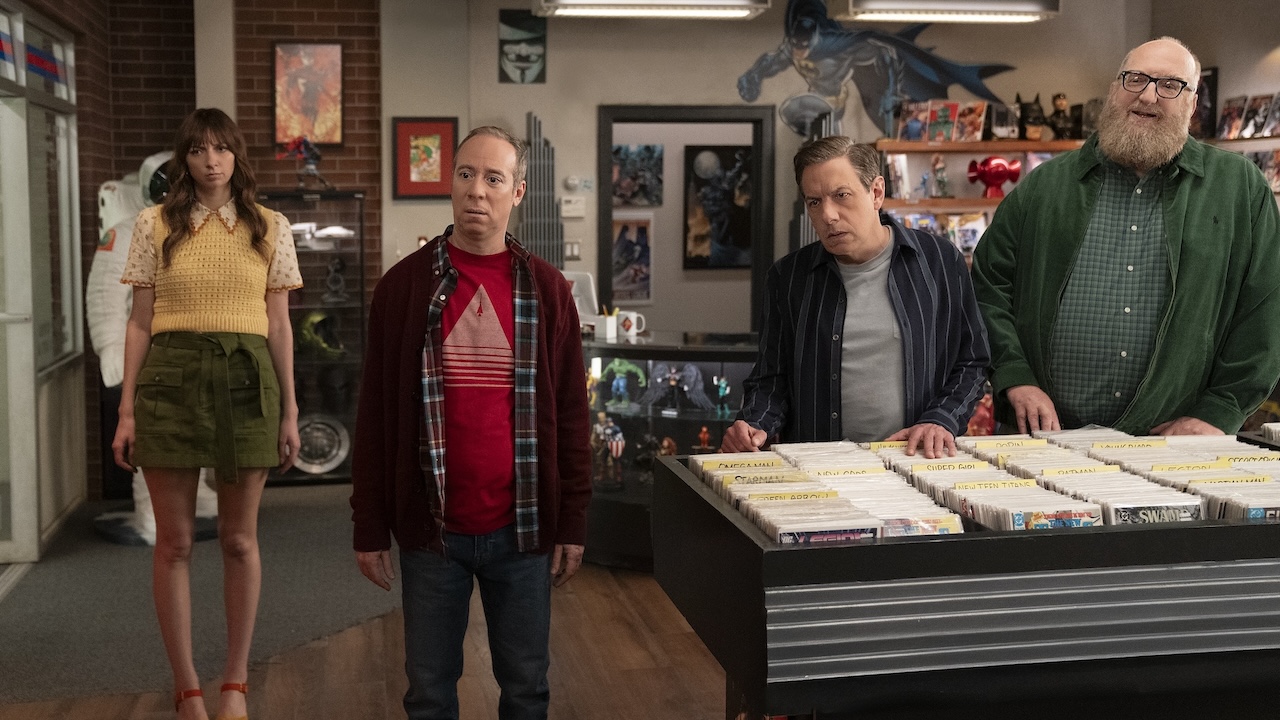 Stuart, Denise, Bert and Barry standing in comic shop looking at something off-screen in Stuart Fails to Save the Universe