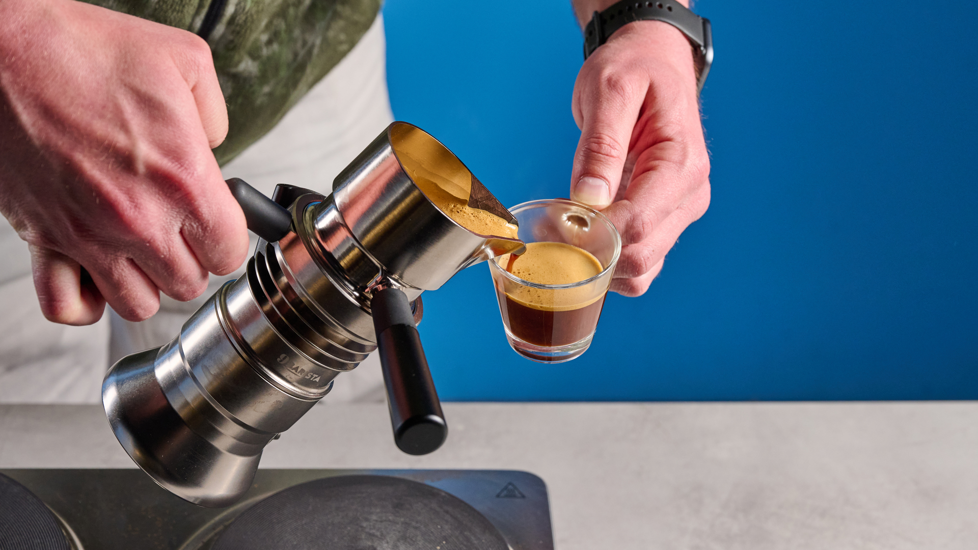 The 9Barista Mk.2 being used to pour espresso into an espresso glass