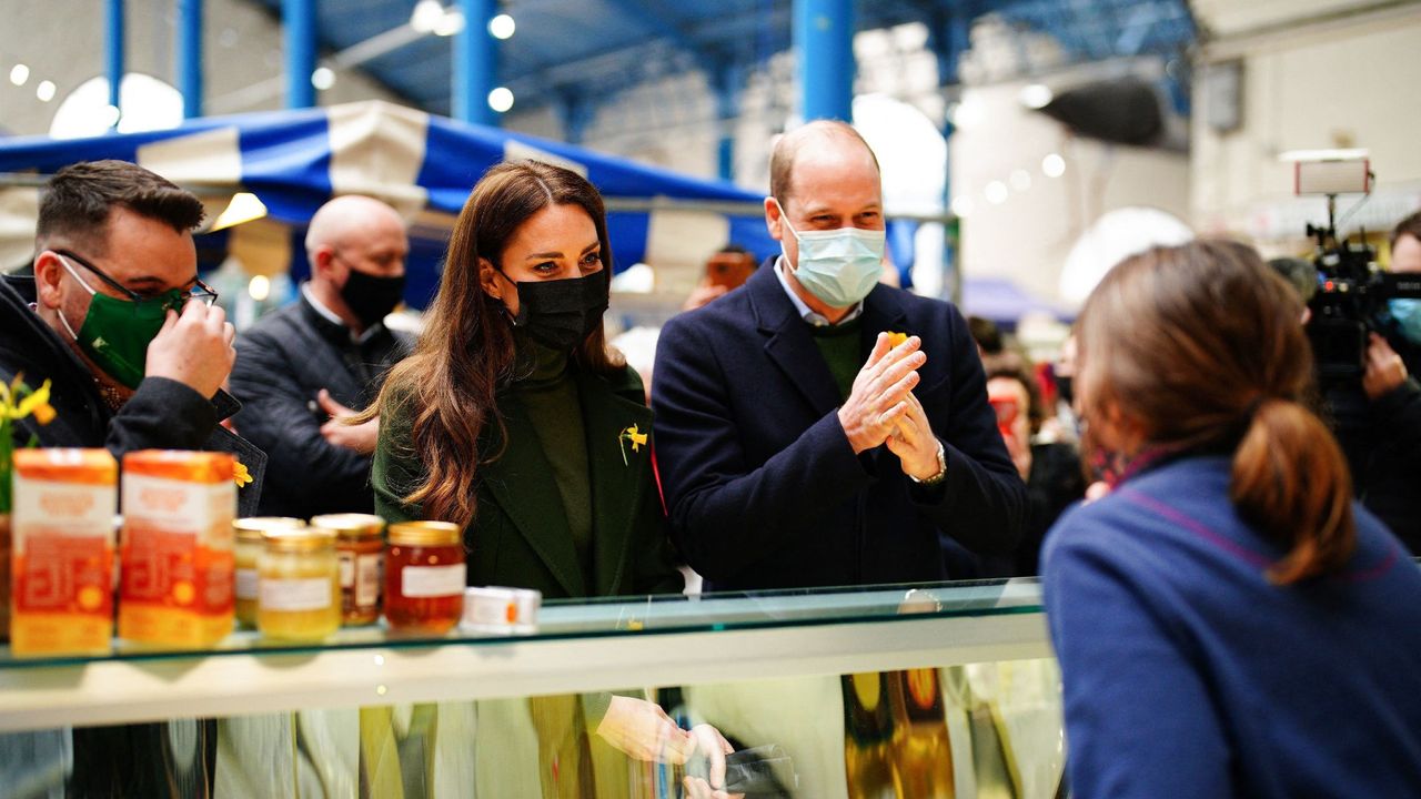 Britain&#039;s Catherine, Duchess of Cambridge, (L) and Britain&#039;s Prince William, Duke of Cambridge, speak with a cheeseseller at her stall at the Abergavenny Market