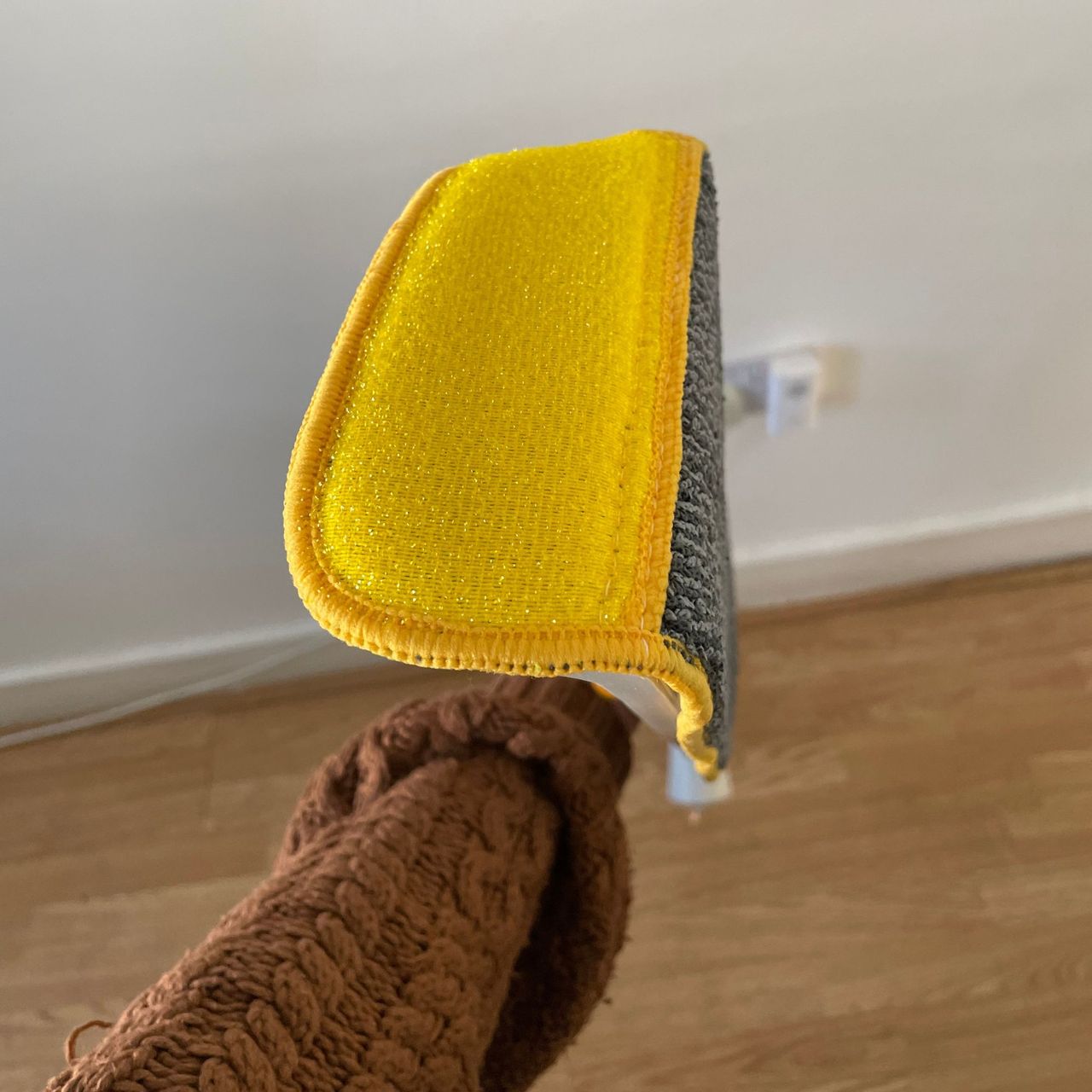 Showing the scrubber edge of the Joseph Joseph CleanTech 2-in-1 Spray Mop