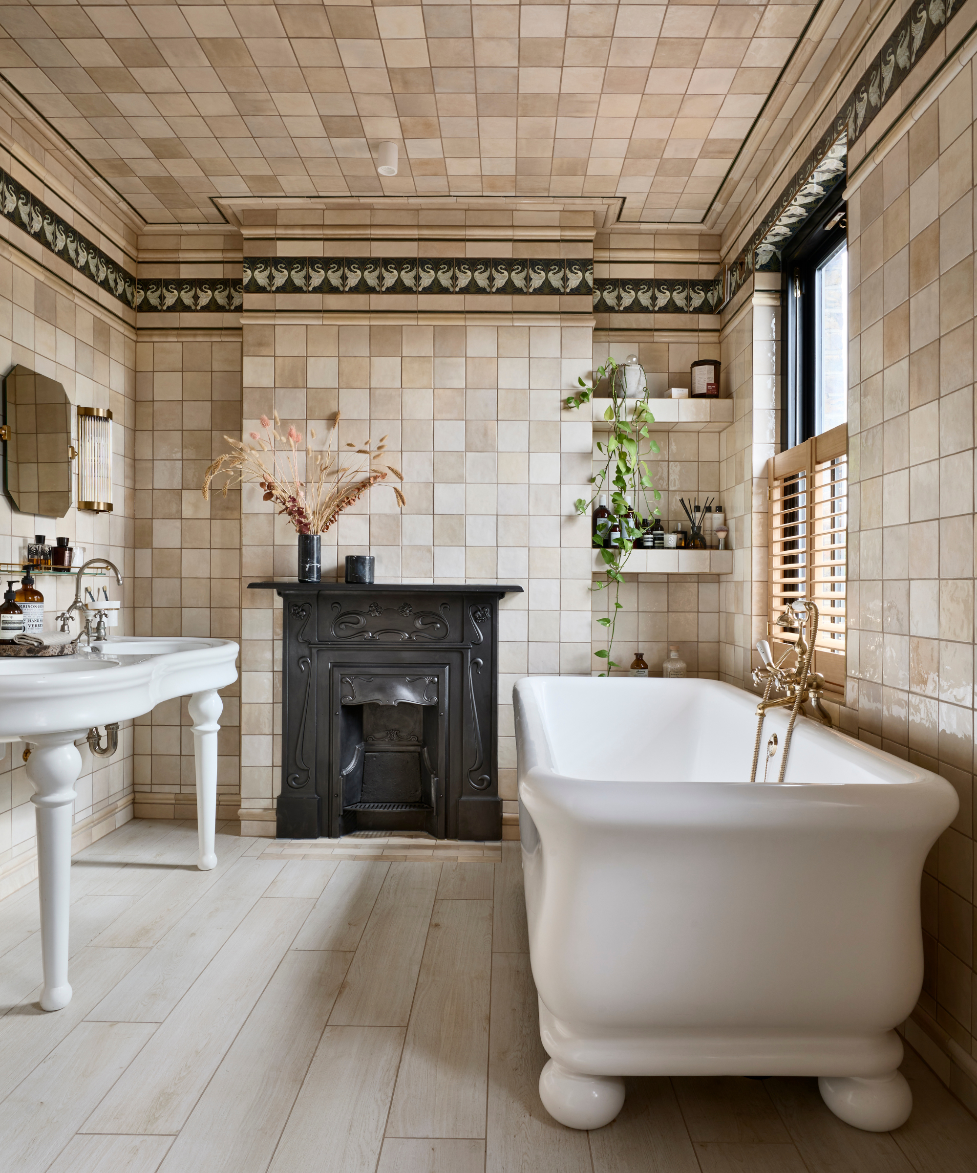 Bathroom with beige square tile and ceiling trim with feature black fireplace