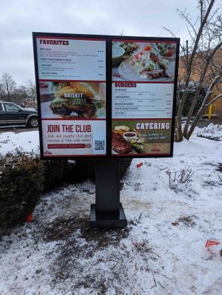 An outdoor digital menu at a drive-in.