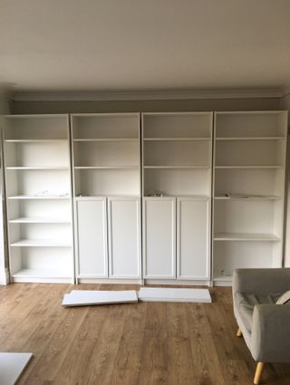 IKEA BILLY bookcase in a living room with wooden floor before makeover