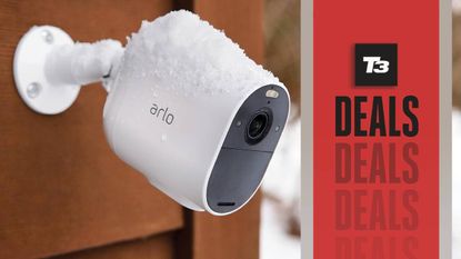 Arlo outdoor security camera in the snow with a T3 deals banner