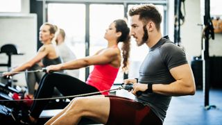 People using rowing machines in a gym