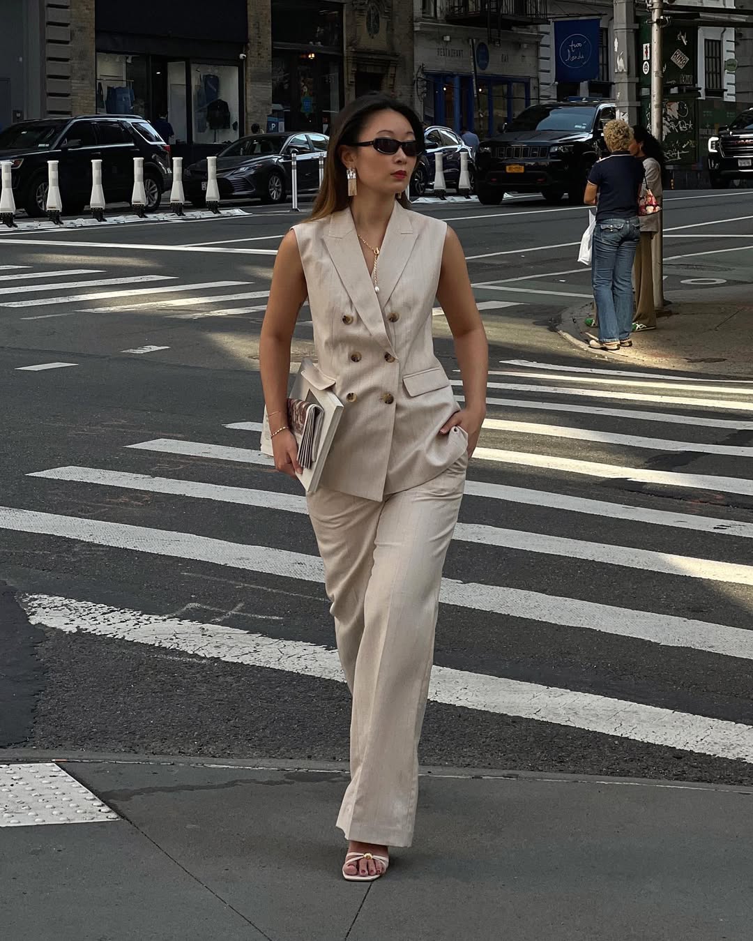 Caroline wearing a sleeveless linen blazer
