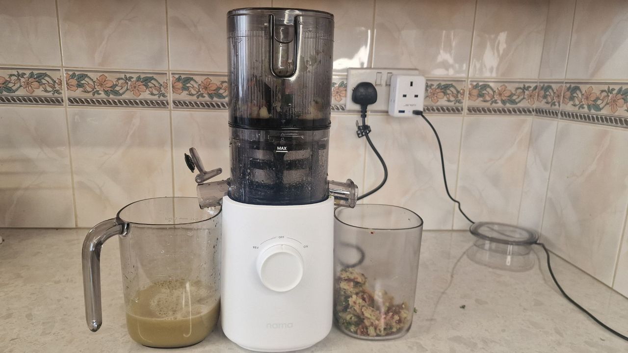 The Nama J3 juicer making a bright orange juice