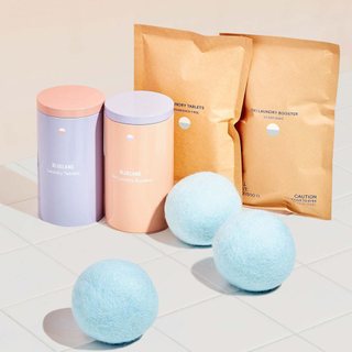 A pastel set of laundry detergent and dryer balls