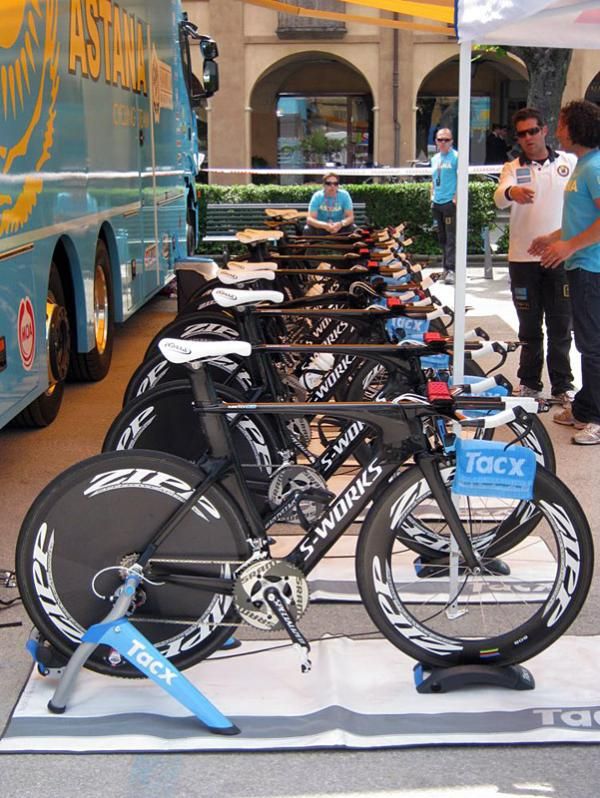 Astana's fleet of Specialized time trial bikes are mounted on trainers, ready for the riders to warm up.