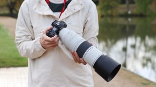 Canon RF 200-800mm f/6.3-9 IS USM lens on a Canon EOS R5 camera held in hands
