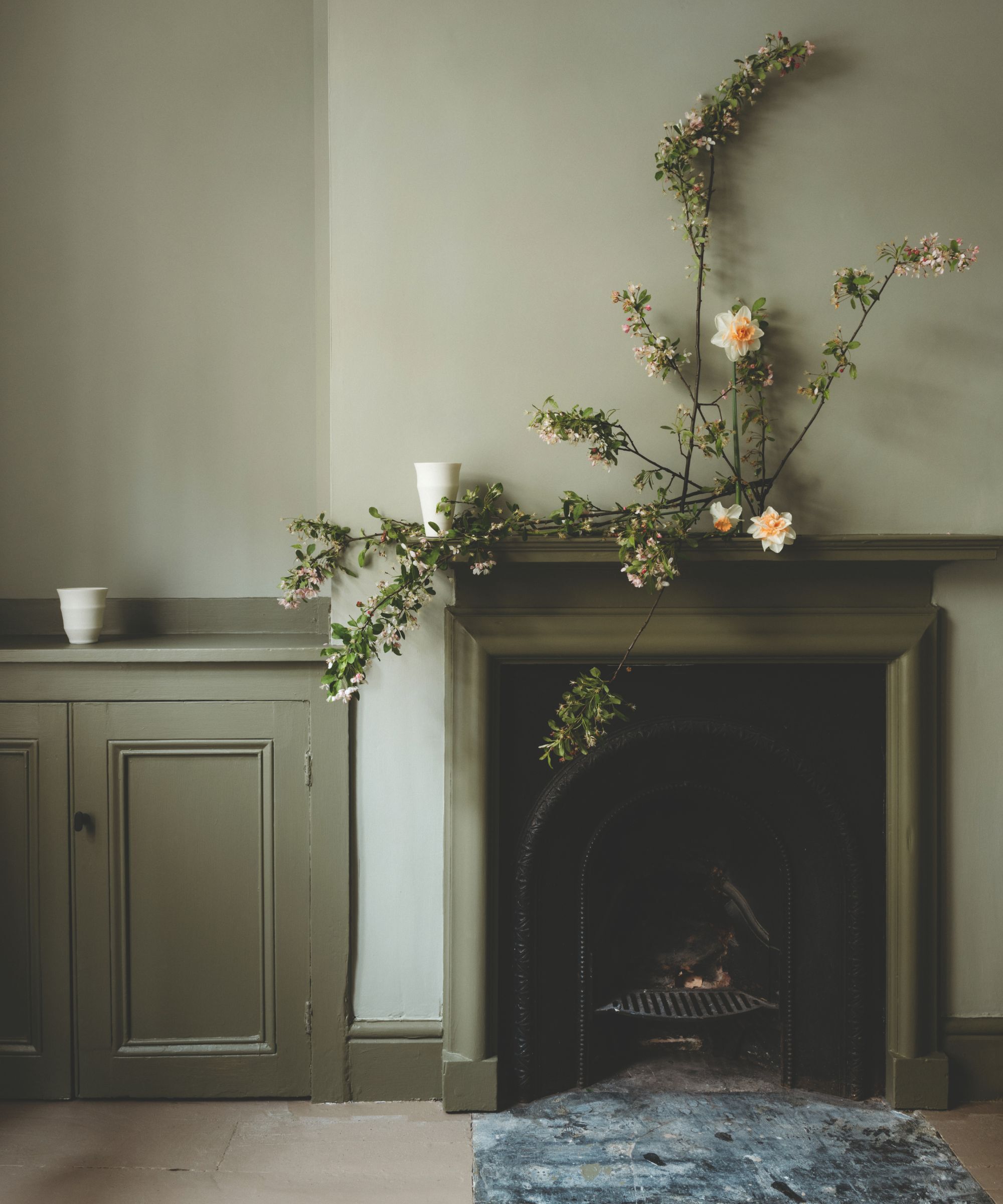 Room and mantlepiece painted in soothing green tones