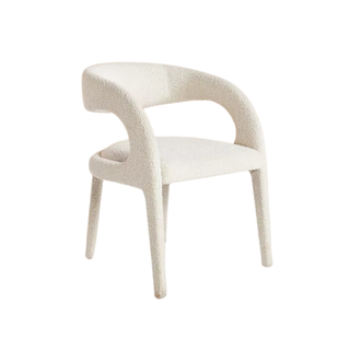 A white bouclé dining chair