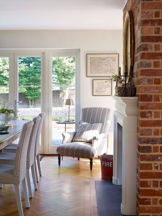 brick chimney breast with dining table and french windows