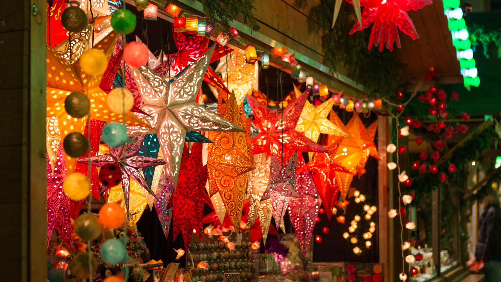 Coloured lights hang from a stall at the Christmas market in Freiburg, Germany