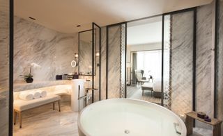 Marble bathrooms feature free-standing baths that look out onto the city views
