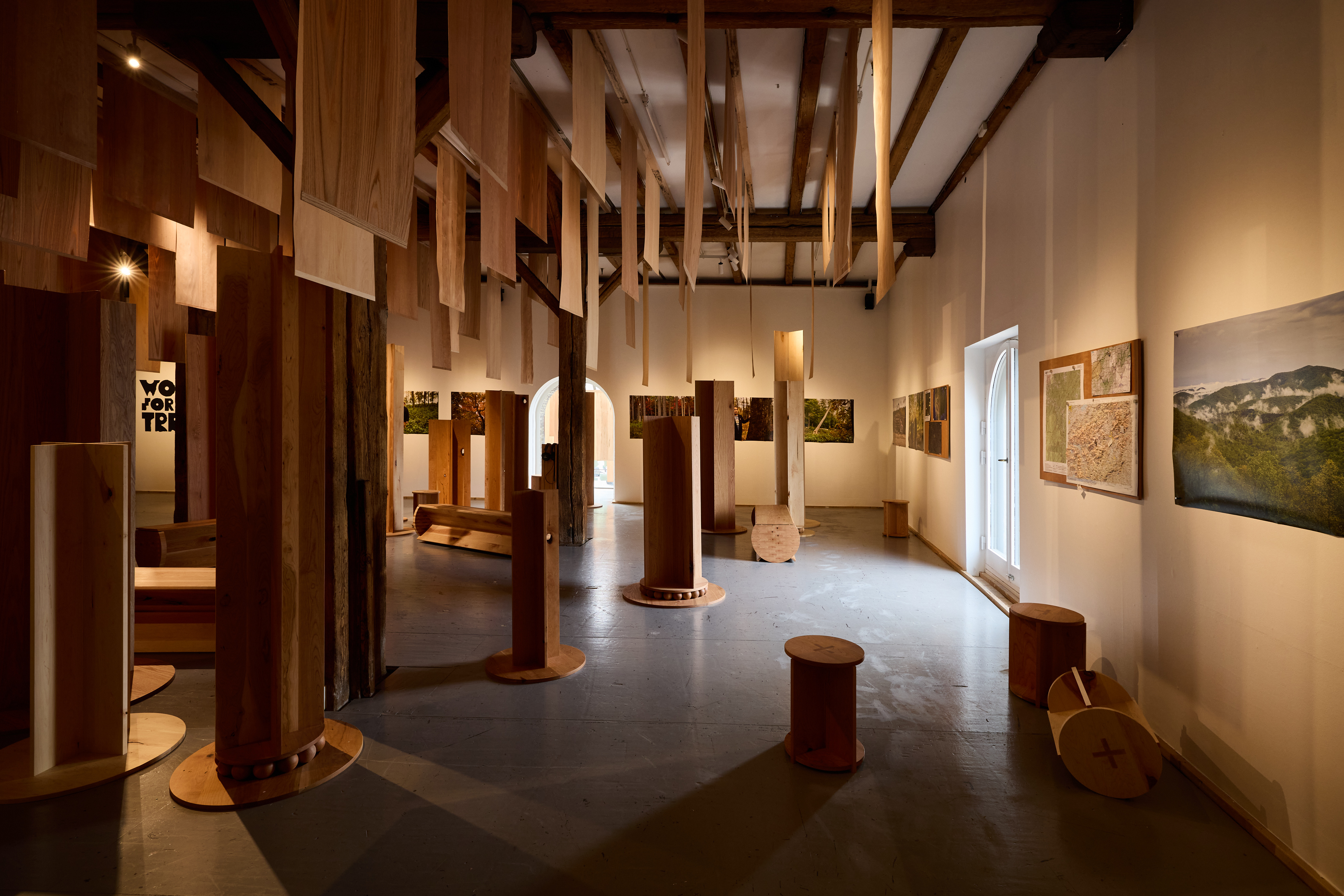 view of timber installationrepresenting an abstract forest, led by ahec, Wood for the Trees Exhibition @ Material Matters 