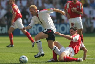 Switzerland's Bernt Haas challenges England's Paul Scholes in a Group B game at Euro 2004.