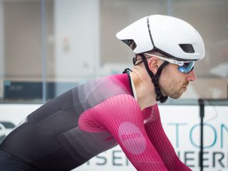 Tom riding in the wind tunnel wearing an aero helmet