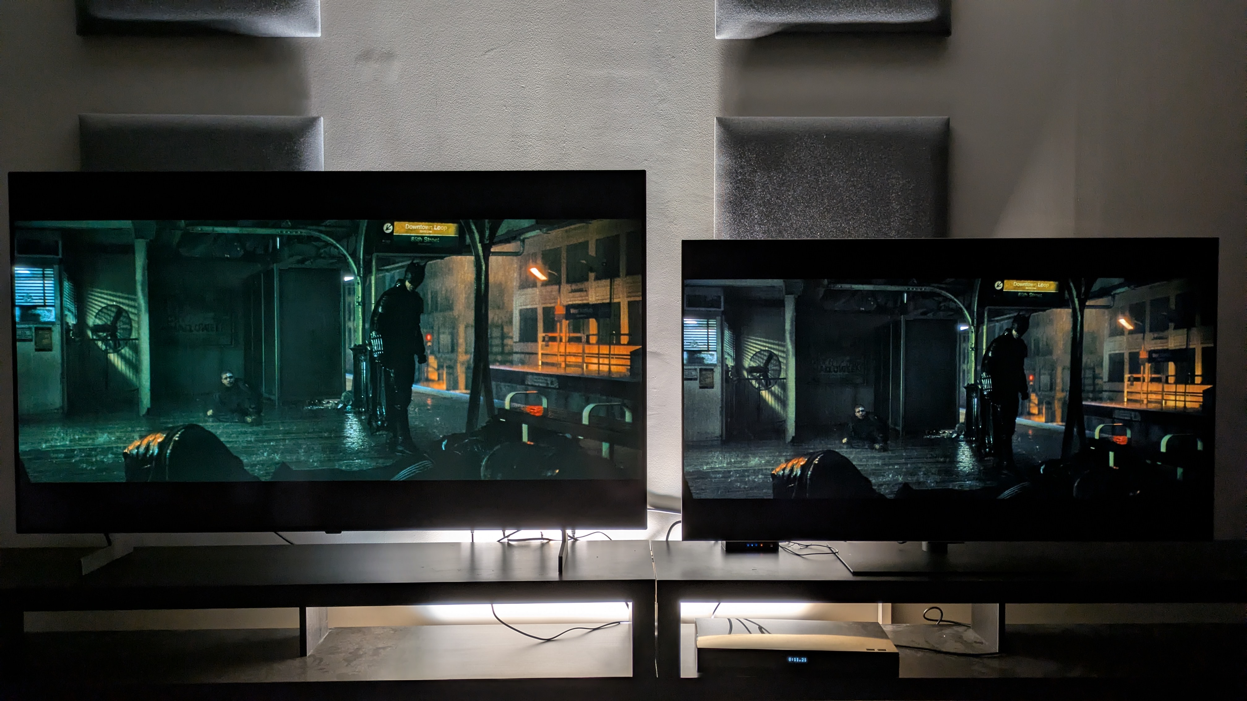 The LG B6 (left) and LG G6 (right) showing The Batman, with Batman stood in dark subway platform. The B6 is showing green tint, made obvious when next to the G6.