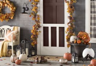 Porch with fall colours, pumpkins and seasonal decorations