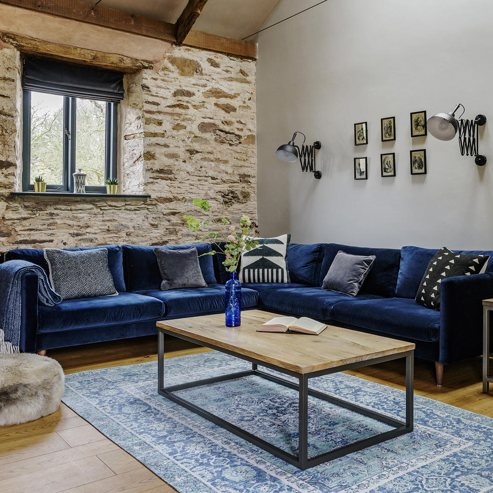 Blue living room with exposed brick wall and a coffee table