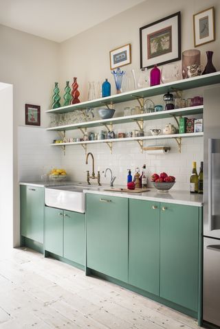 Green kitchen with colorful kitchen shelves