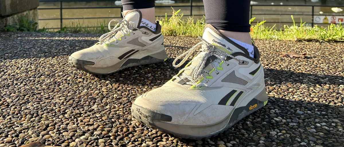 Woman&#039;s feet wearing Reebok Nano X3 Adventure shoes - front view