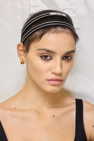 Model backstage at Dior S25 show wearing waterline eyeliner