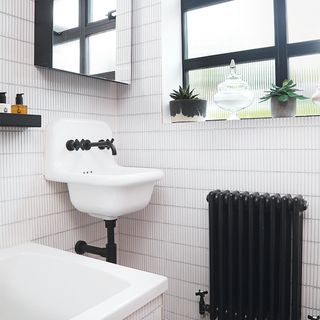 small bathroom with white tiles and black fittings