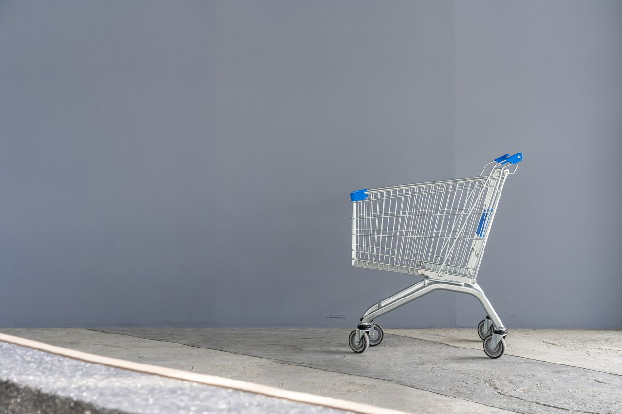 Empty shopping cart on a gray background