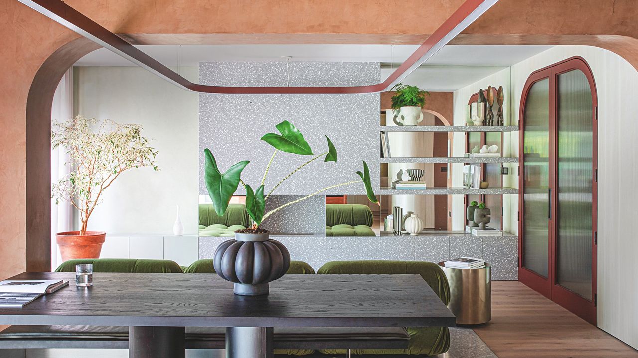 The living area with arched ceilings and doorways with accents of red and green 