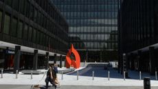 Front of the Irish HSE's headquarters in Dublin, a dark skyscraper with a red statue in front