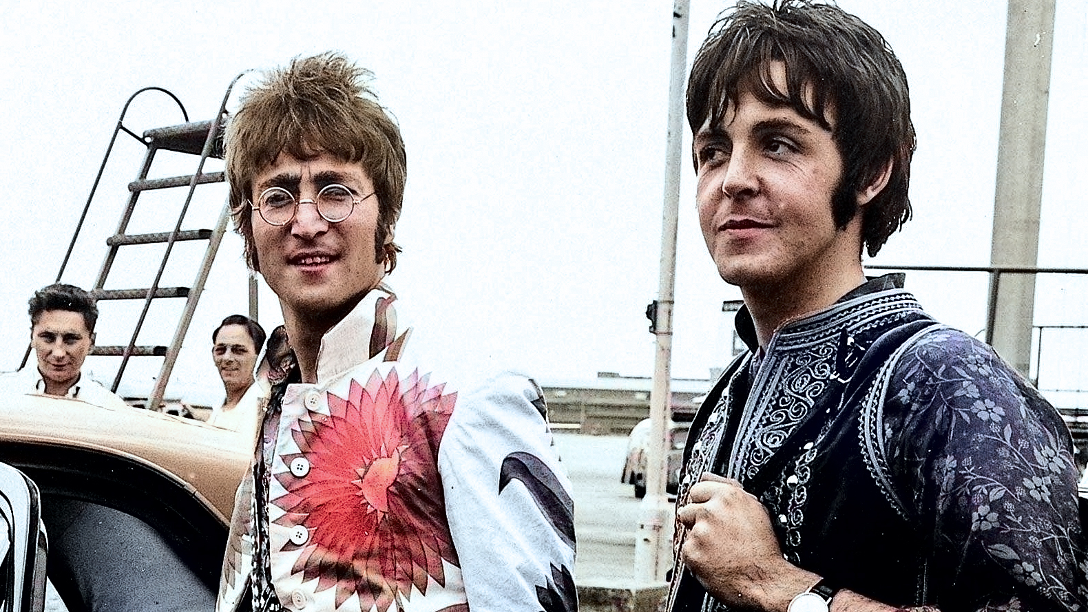 Paul McCartney and John Lennon arrive in England from Greek holiday wearing psychedelic clothes July 1967