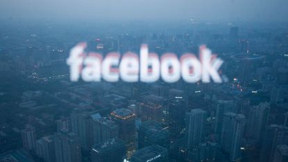 The Facebook logo reflected over the Beijing skyline