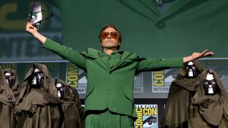 Robert Downey Jr wearing a green suit and sunglasses during Marvel's Hall H panel at San Diego Comic-Con 2024