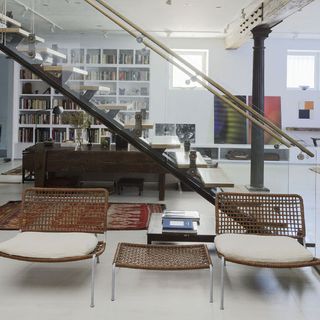 hallway with open stairs and bookshelf