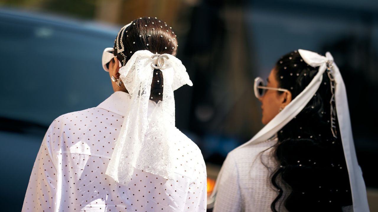 girls at paris couture week with white bows in their buns