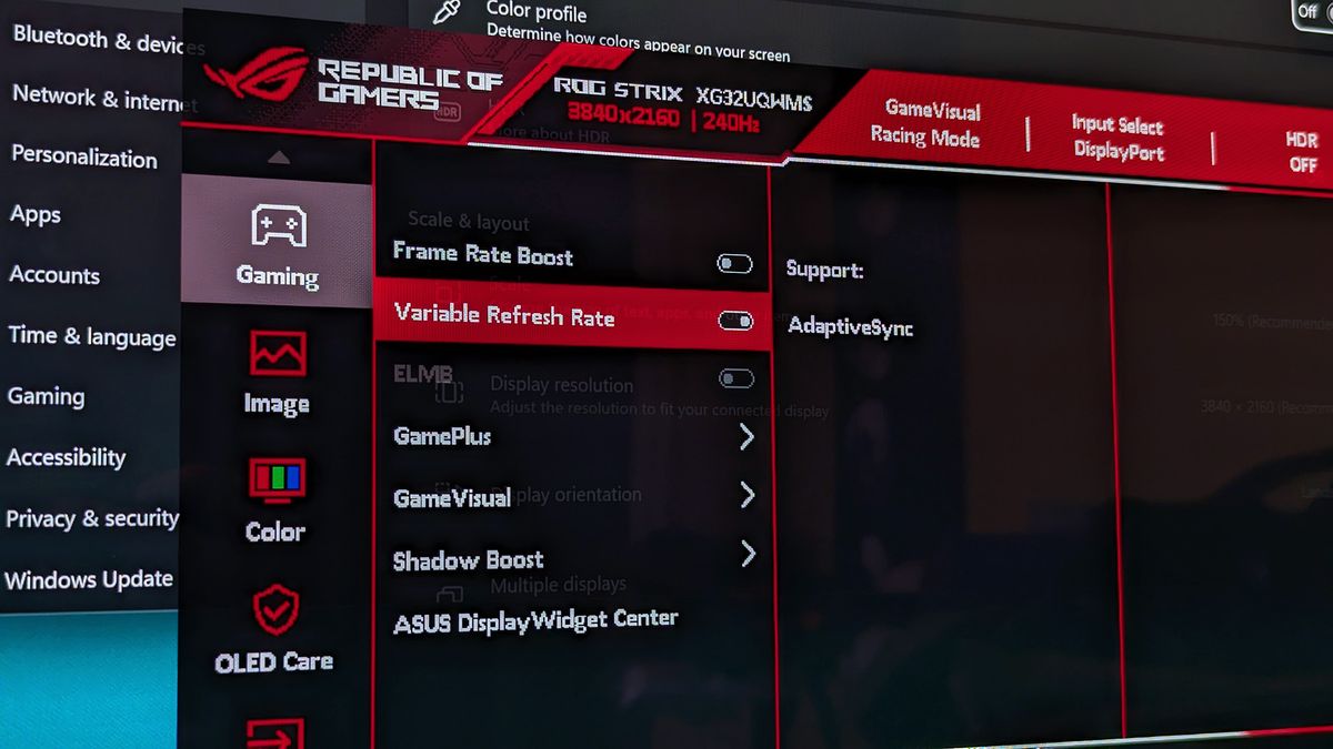 The ASUS ROG Strix OLED XG32UQWMS monitor shows its on‑screen display open to gaming settings, highlighting Variable Refresh Rate and AdaptiveSync options.