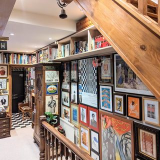 gallery wall on staircase with shelving