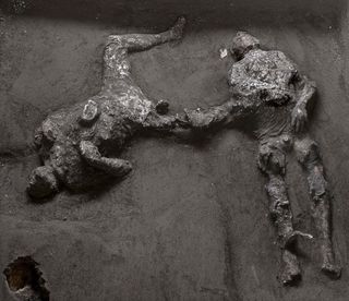 images of bodies of two people buried by pyroclastic flow at Pompeii