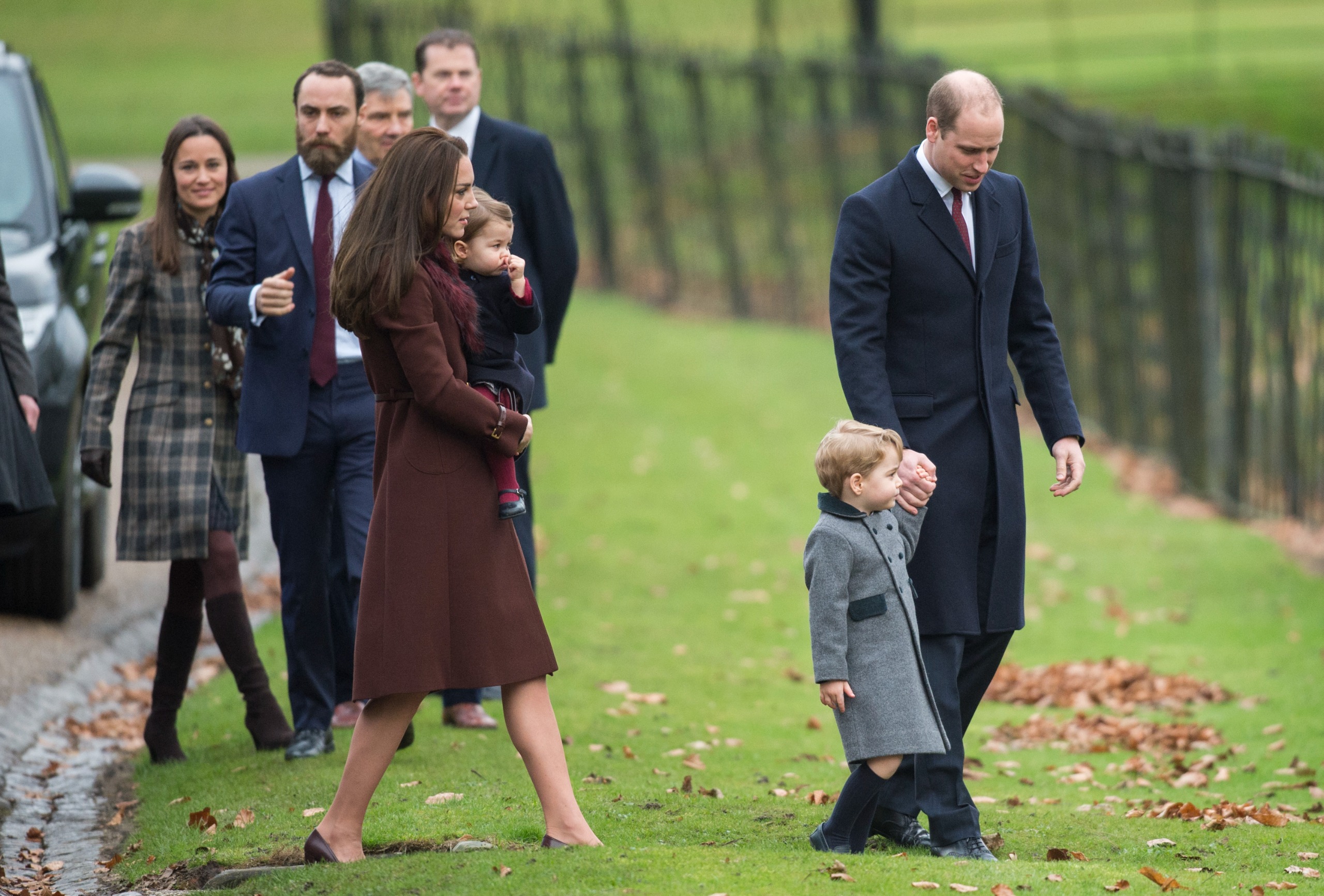 Prince William holding hands with Prince George, Princess Kate holding Princess Charlotte and Pippa and James Middleton walking behind them on Christmas Day 2016