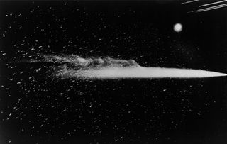 Halley's Comet as photographed May 13, 1910, by a wide-angle camera at Lowell Observatory, Flagstaff, Ariz., during the comet's last appearance. A streak across the comet near the coma is a meteor trail, and not a scratch on the negative. Streaks at the b