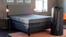 The Layla Hybrid Mattress on a bed beside a Layla mattress delivery box.