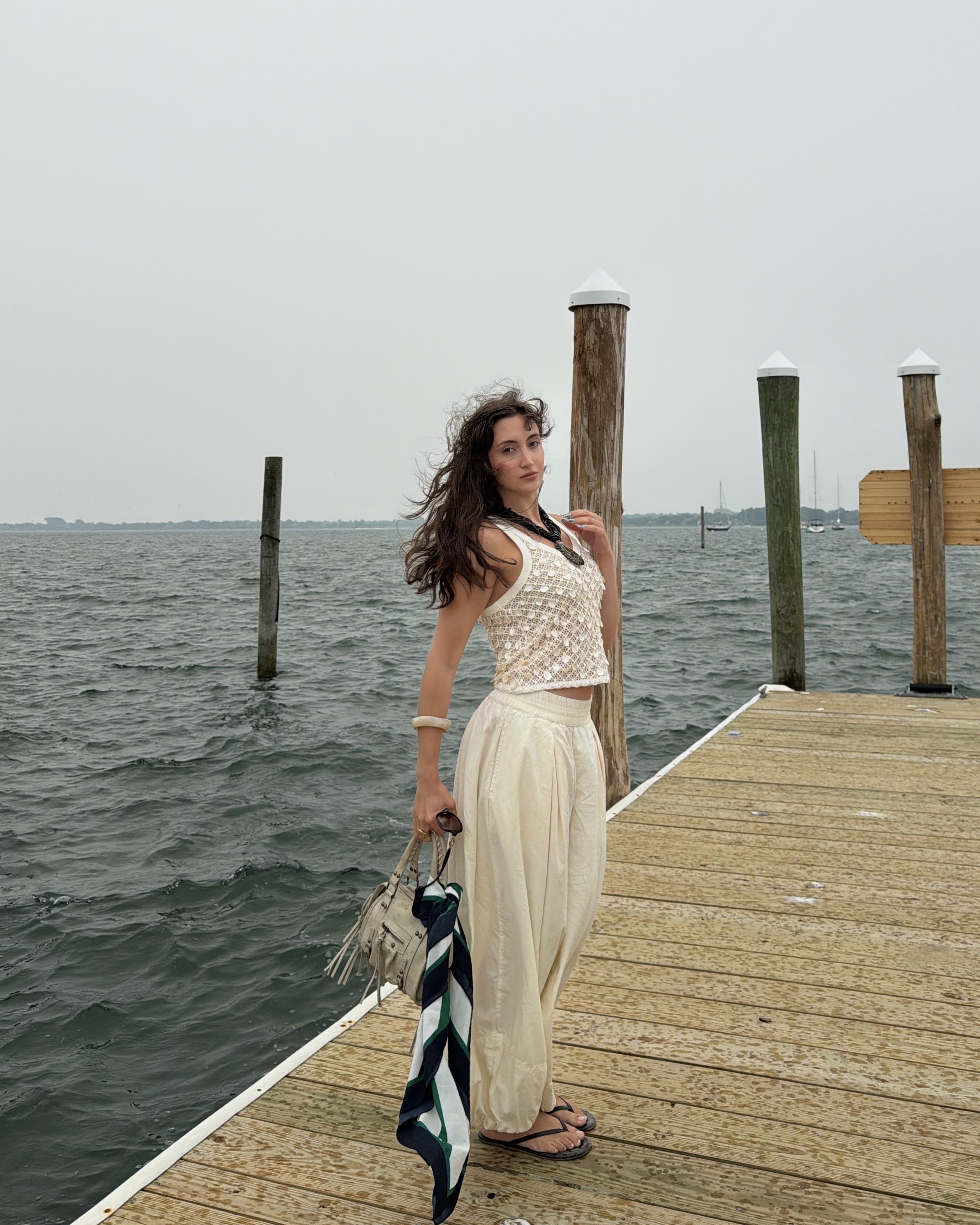 An image of Who What Wear associate beauty editor Alyssa Brascia with wavy hair blowing in the wind.
