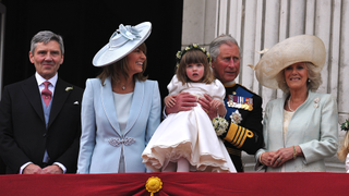 Michael Middleton, Carole Middleton, Prince Charles, Prince of Wales holding bridesmaid Eliza Lopes and the Camilla, Duchess of Cornwall on the balcony at Buckingham Palace after the Royal Wedding of Prince William to Catherine Middleton on April 29, 2011 in London, England