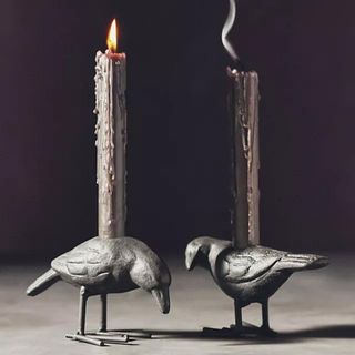 Two black candles in crow-shaped holders from Anthropologie