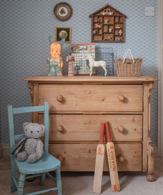 chest of drawers in a children's bedroom with vintage accessories