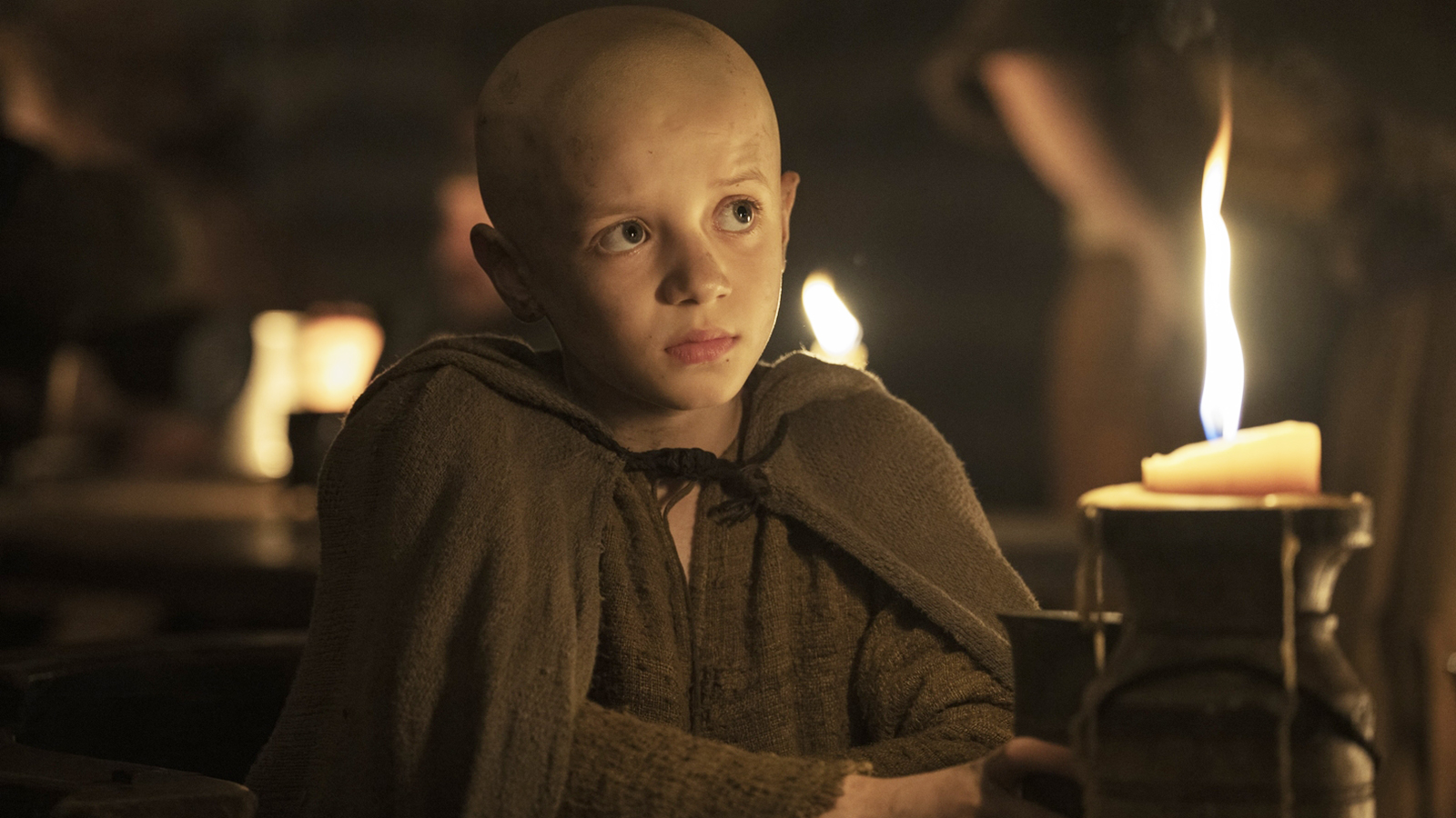 Egg sitting in a dark tent next to a lit candle in A Knight of the Seven Kingdoms episode 2