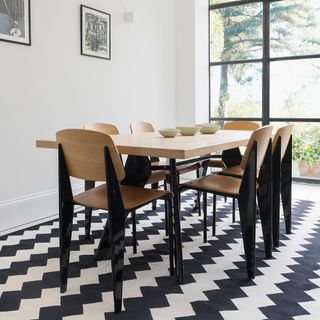 dinning table with white walls and chairs